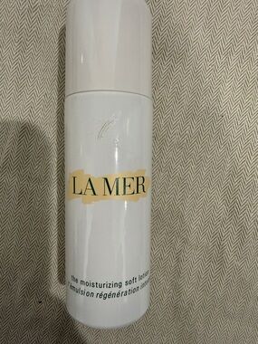 La Mer White Bottle with Gold Accent and Green Logo
